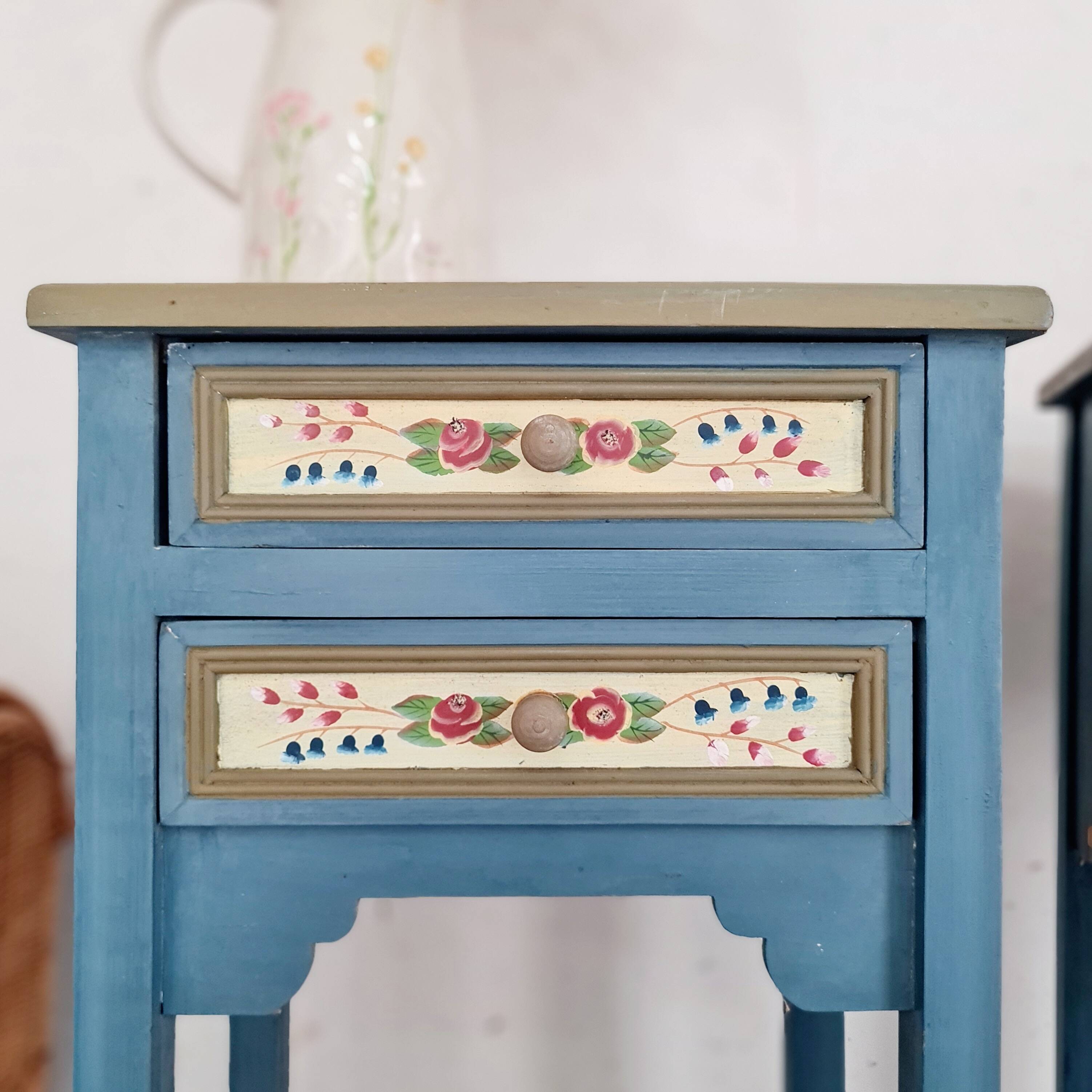 Blue wooden bedside tables with floral patterns