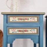 Blue wooden bedside tables with floral patterns