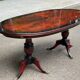Glossy mahogany dining table in English Regency style from the 1970s.