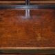 Antique entrance bench by Jas Shoolbred with brass fittings and walnut frame circa 1890.