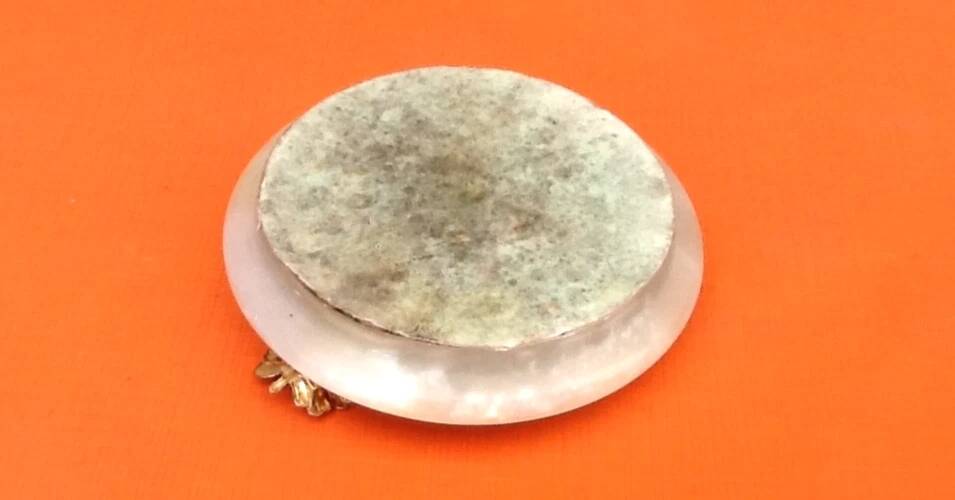 1970s Onyx ashtray with a gold metal rim.