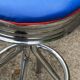 Set of 5 vintage swivel bar stools in blue, red, orange, and yellow.