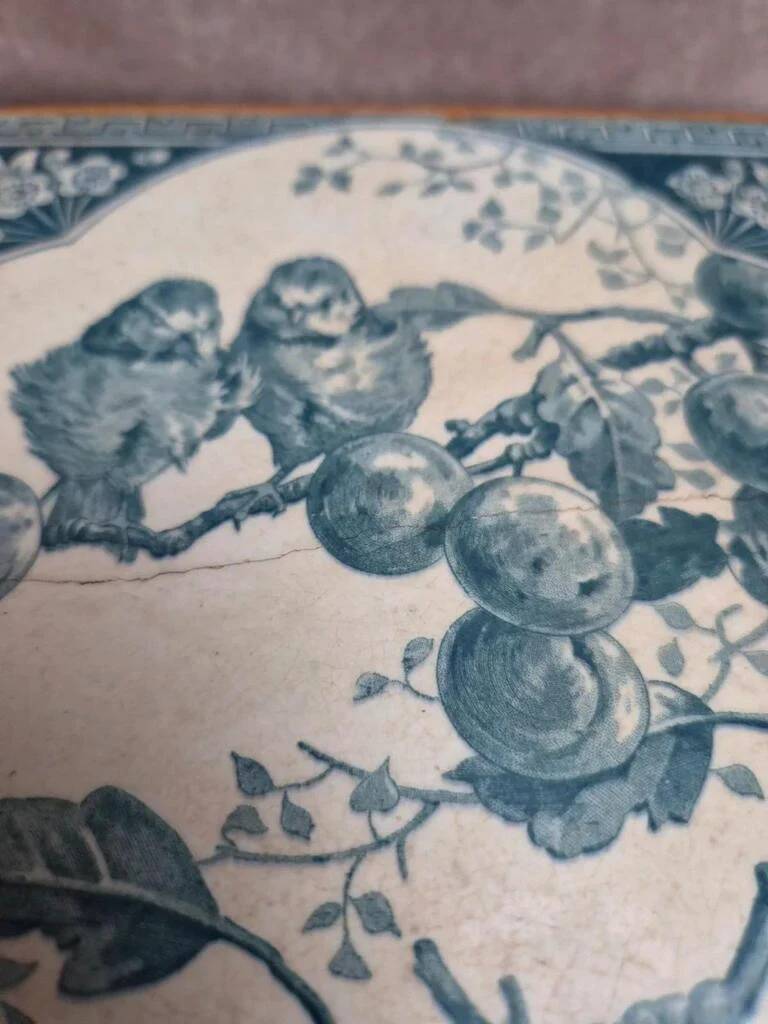 Antique trivet in Gien tile with blue bird decoration – wooden border