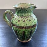 Old pitcher with ethnic decor