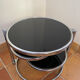 Coffee table with pivoting metal and black glass elements.