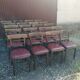 Set of 19 vintage wooden bistro chairs with red faux leather.