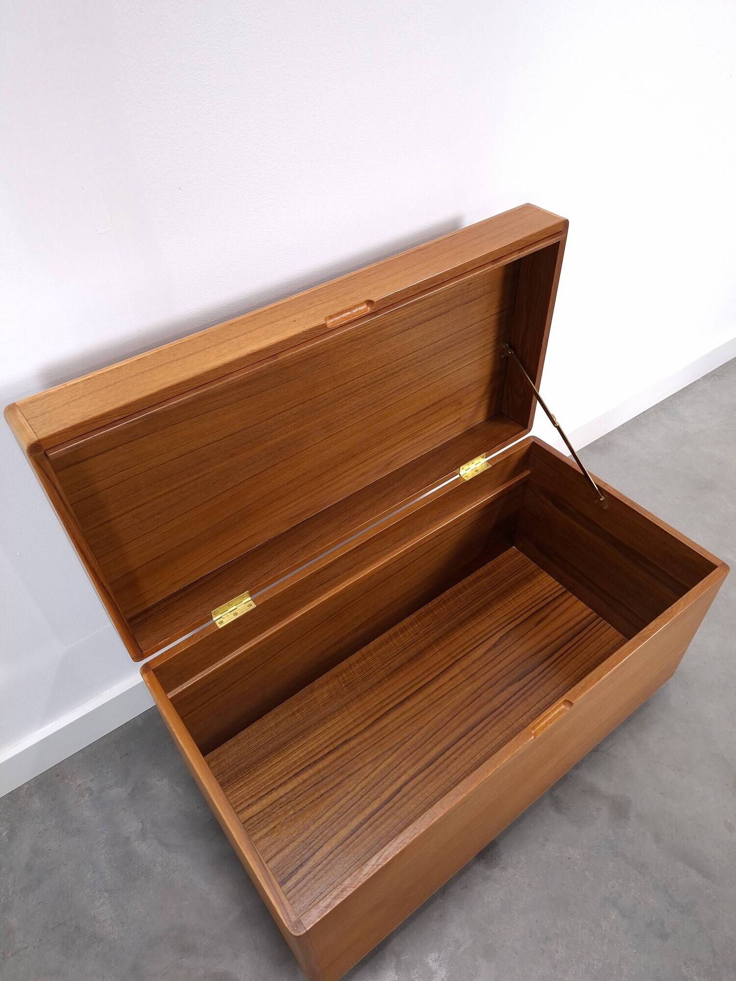 Vintage teak Danish chest with a lid on wheels, toy chest.
