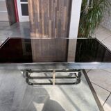 Coffee table with chrome base and mirrored glass top, vintage solar flare decor