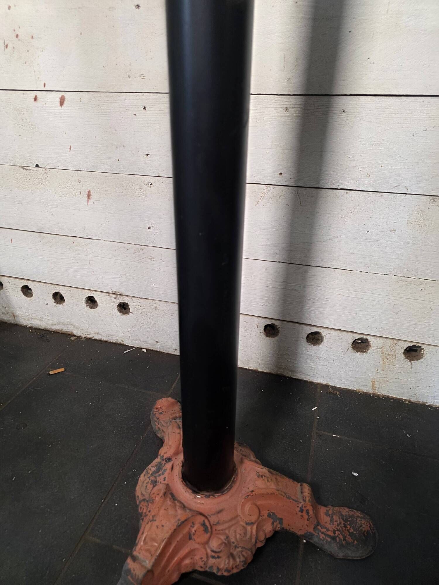 Bistro standing table with marble top and cast iron base.