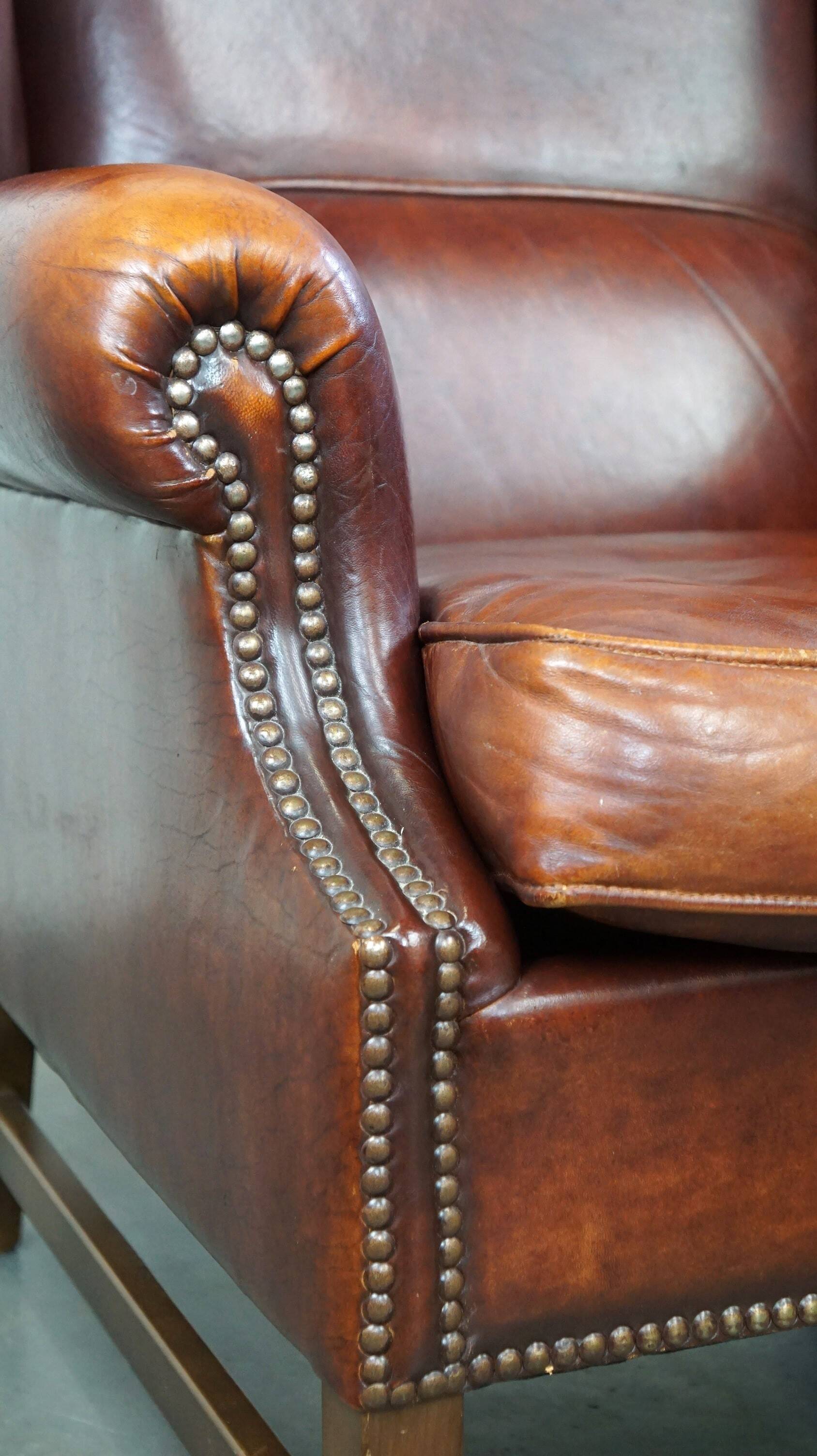 Large comfortable sheepleather wingchair in good condition and beautiful colours