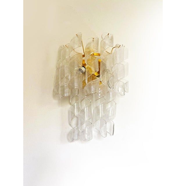 A pair of transparent “ricci” murano glass wall sconces