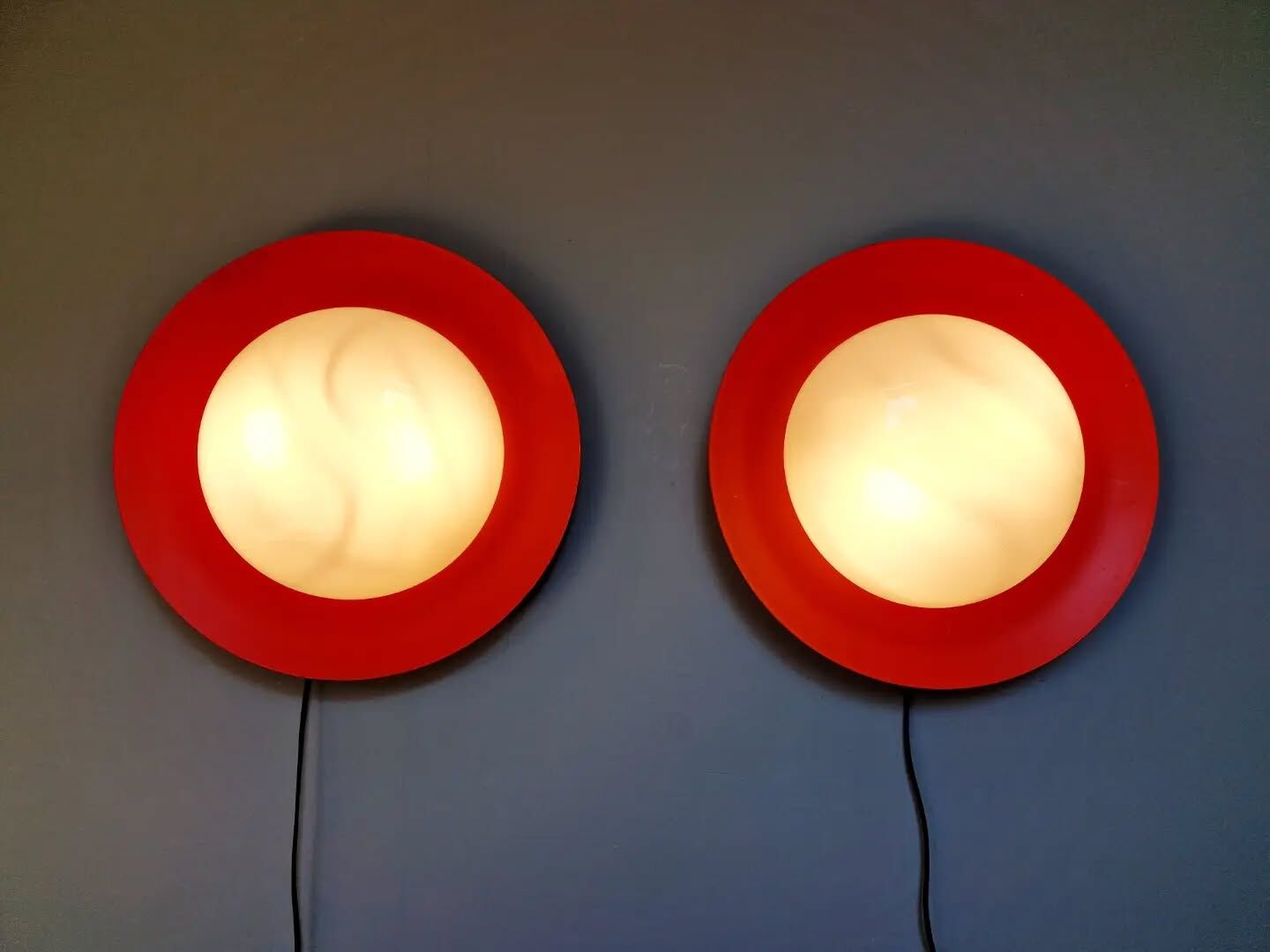 Pair of XXL Space Age wall sconces, orange lacquered metal and opaline, 1960.
