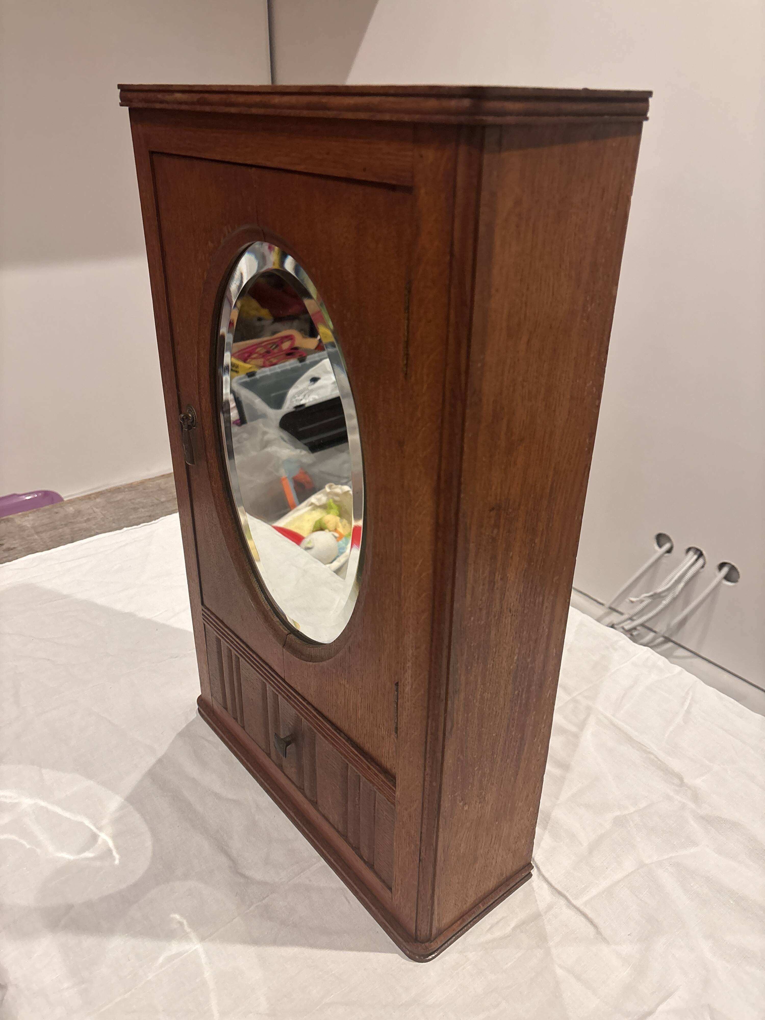 Wall cabinet with oval wall and drawer