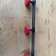 Wall coat holder in vintage red metal.