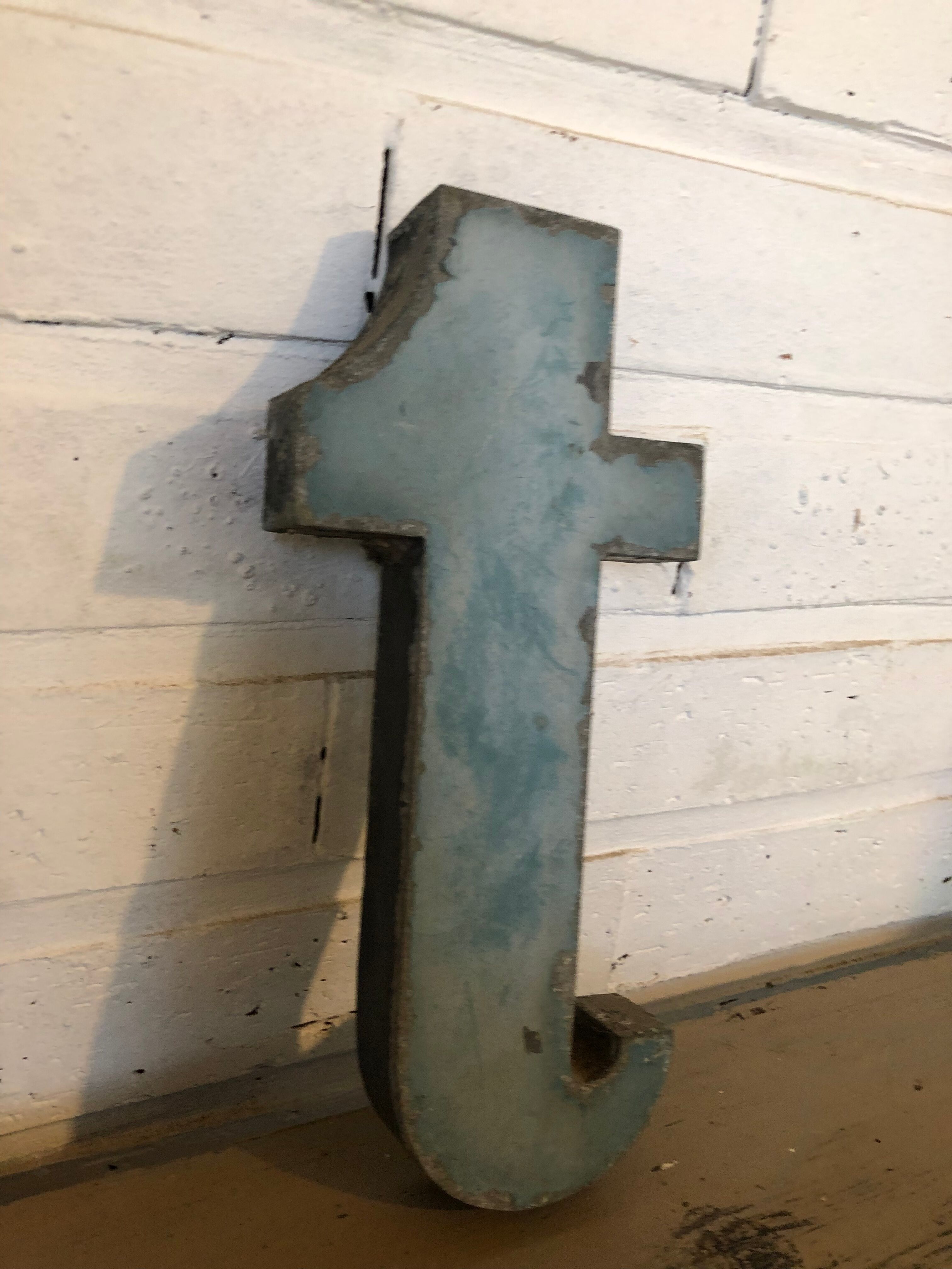 Blue sign letter "T"