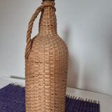 Old high wicker glass bottle
