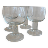 Set of 4 stemmed glasses. In good condition with some signs of wear.