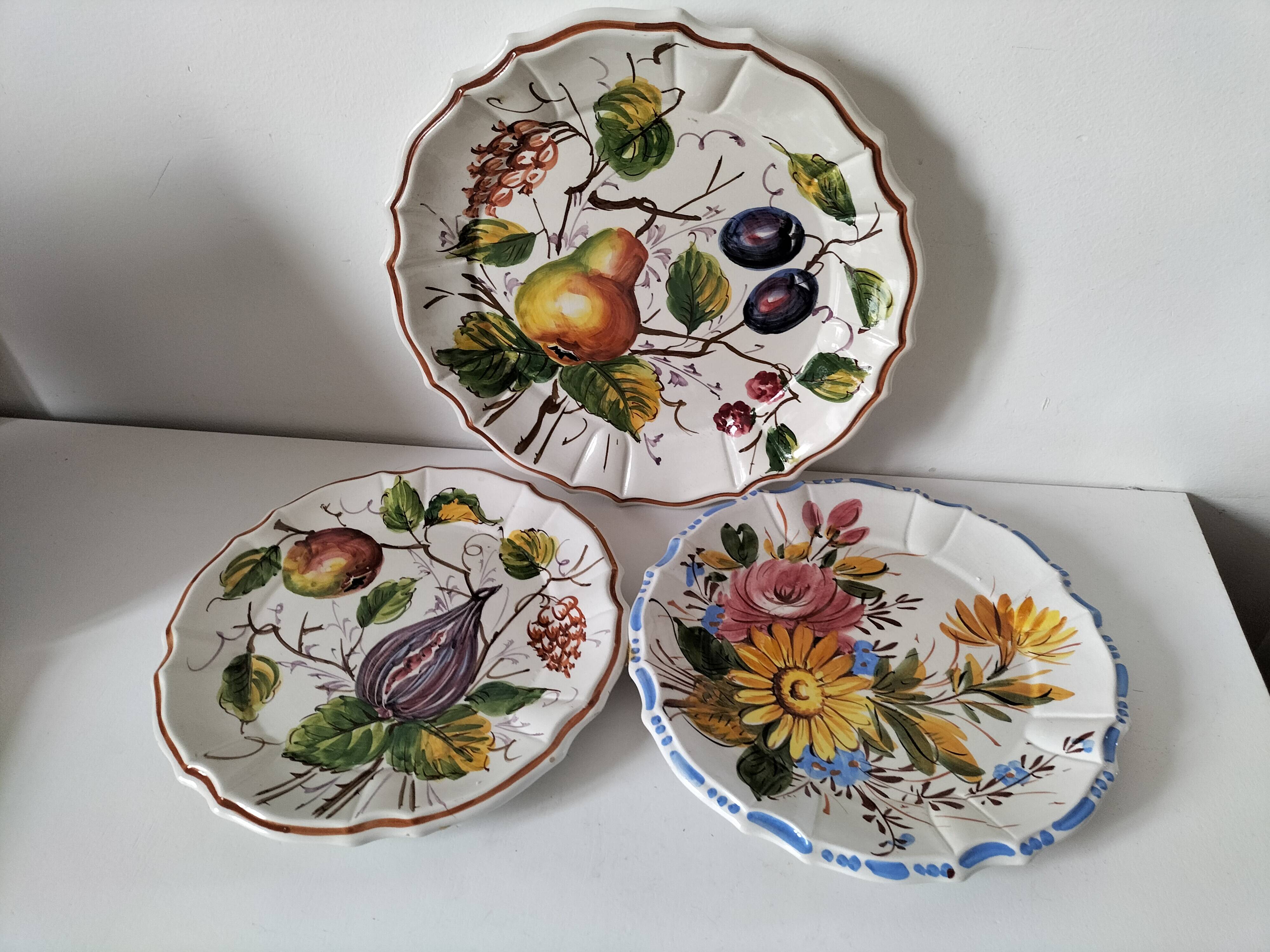 Set of three earthenware plates from Bassano, hand-painted with fruit and flower designs.
