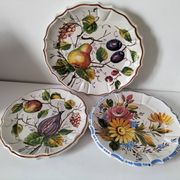Set of three earthenware plates from Bassano, hand-painted with fruit and flower designs.
