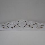 Decorative pediment in white carved wood