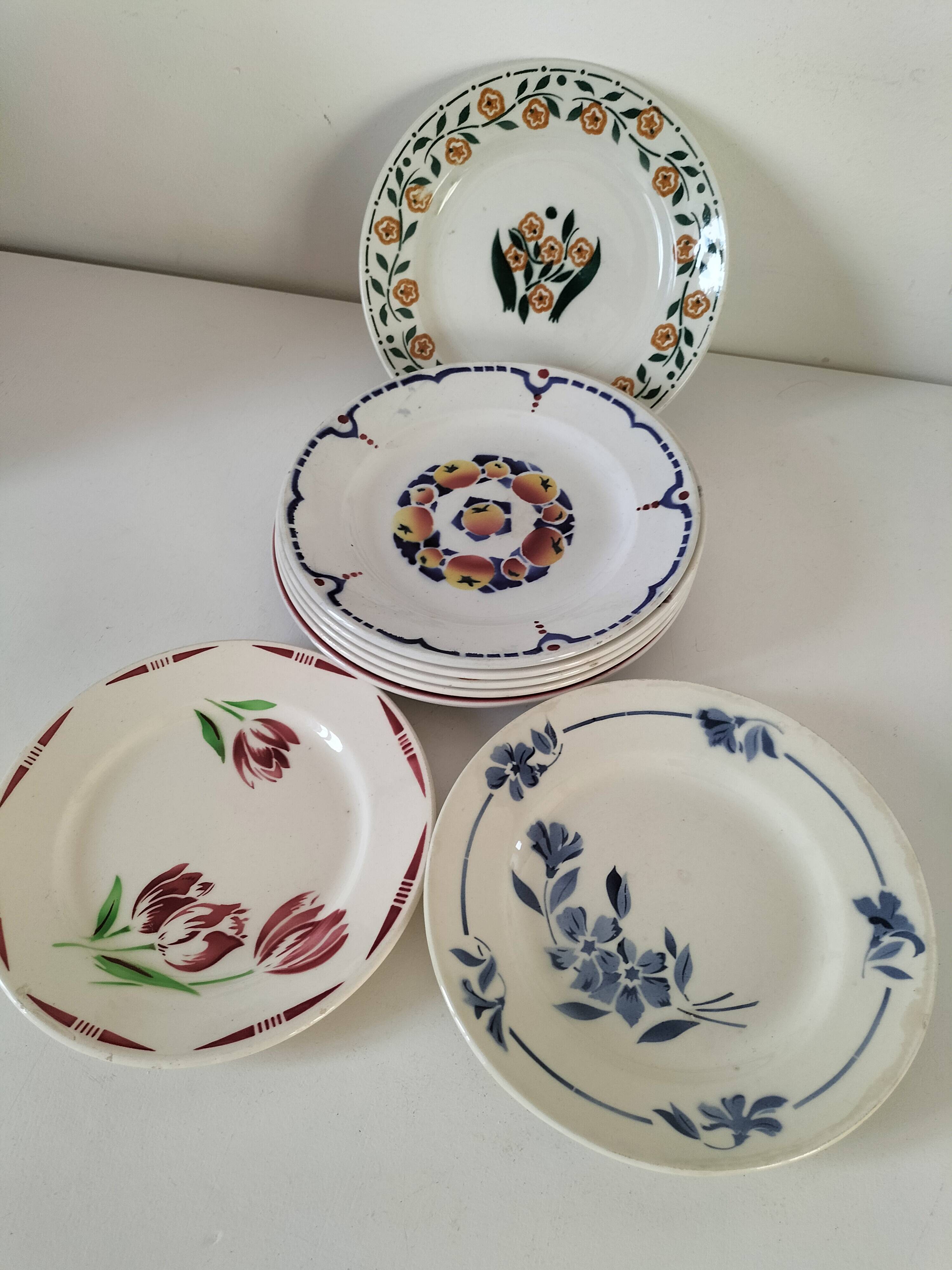 Set of 8 ironstone plates with coordinated designs.