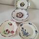 Set of 8 ironstone plates with coordinated designs.
