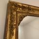 Nineteenth century mirror in wood and stucco gilded with rich gold leaf ornamentation, 101x127 cm