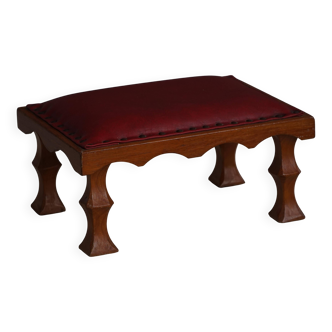 Danish sculpted oak stool from the mid-20th century with a red leather seat, 1950s.