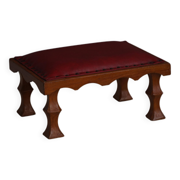 Danish sculpted oak stool from the mid-20th century with a red leather seat, 1950s.