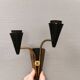 A set of wall lamps in black lacquered metal with brass details