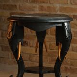 Side table in hardwood ebony with three elephant head-shaped legs, Eastern India, 1920s.