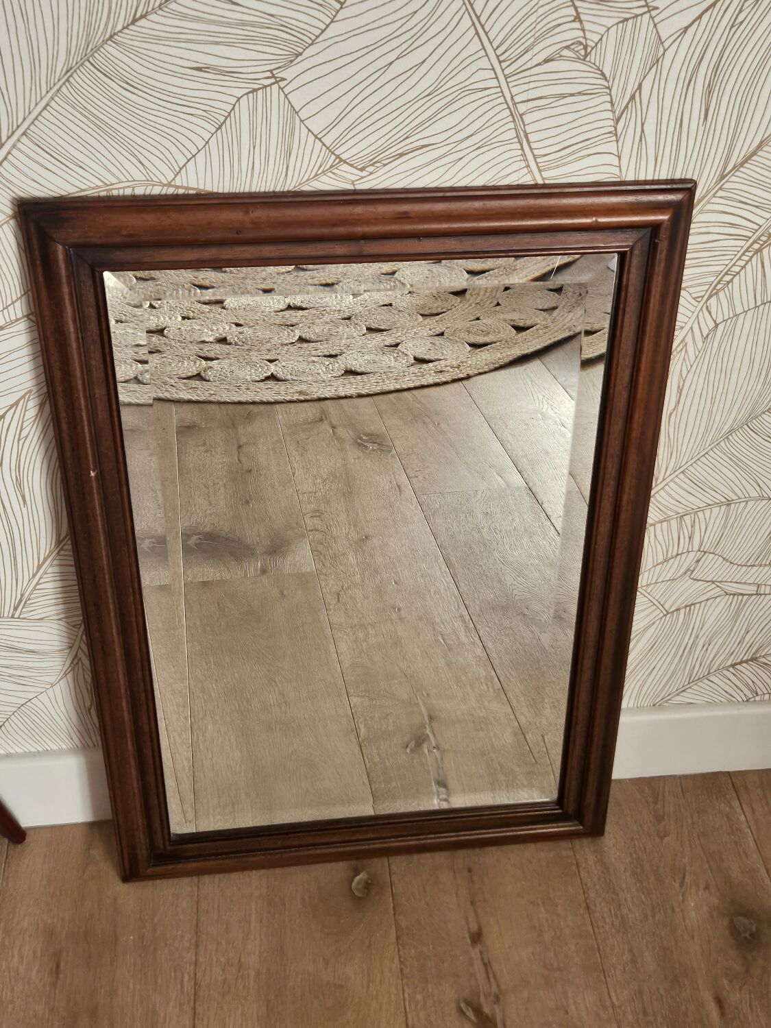 Beveled glass mirror in its wooden frame