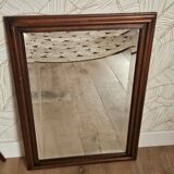Beveled glass mirror in its wooden frame