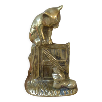 Golden brass cat figurine on fence looking at a mouse in a Vintage India shoe