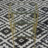 Nested tubular tables in gold metal.
