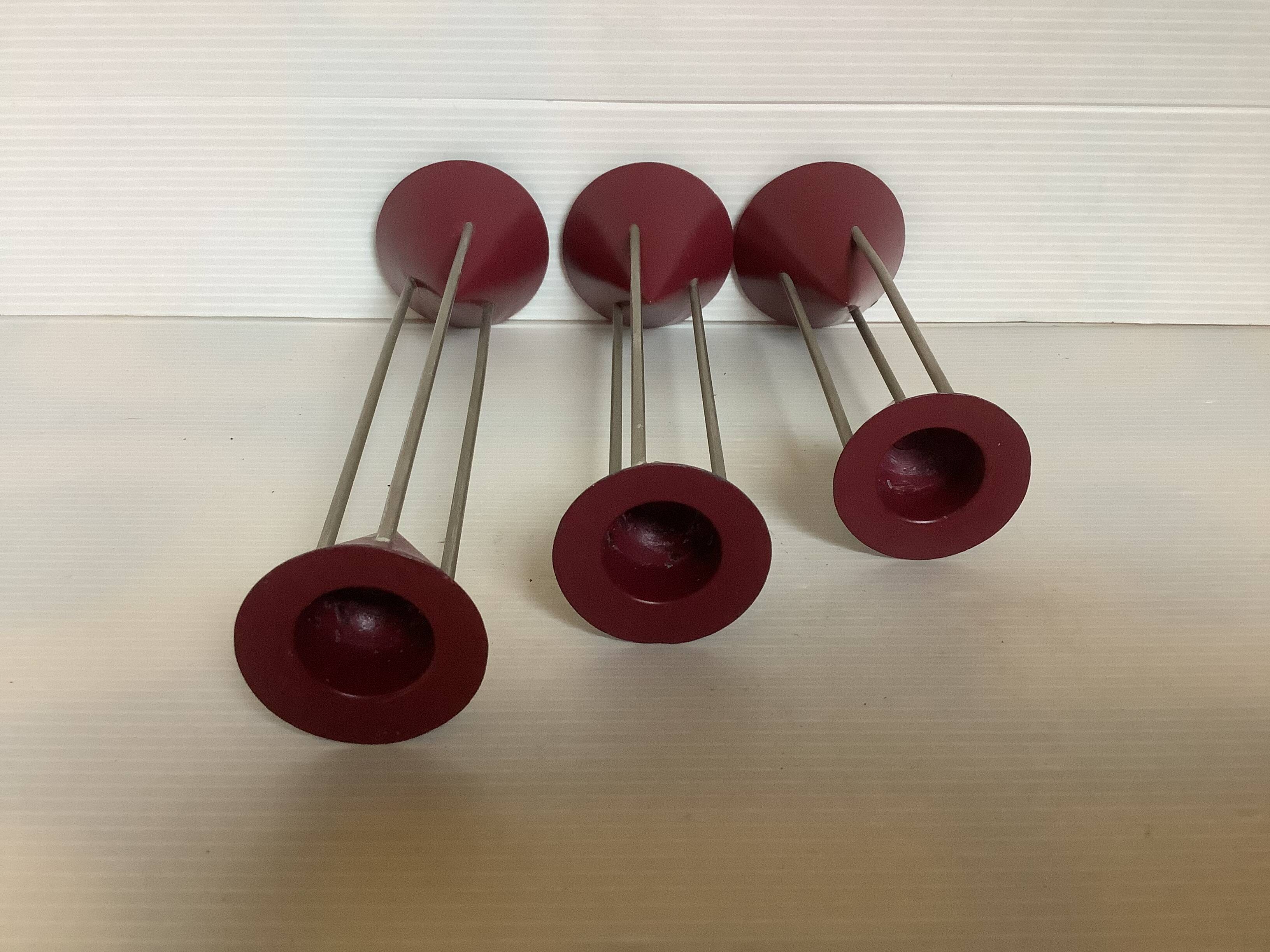 Trio of vintage burgundy candlesticks