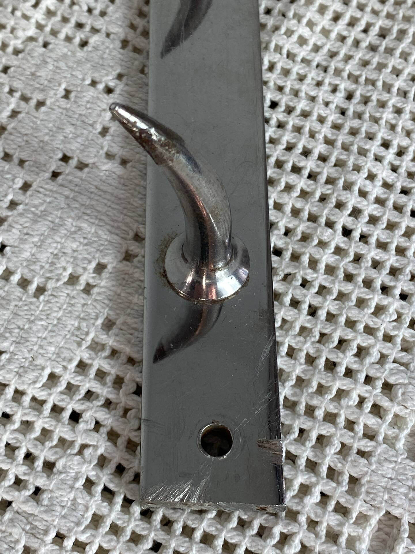 Stainless steel butcher's hook, known as a "wolf tooth bar."
