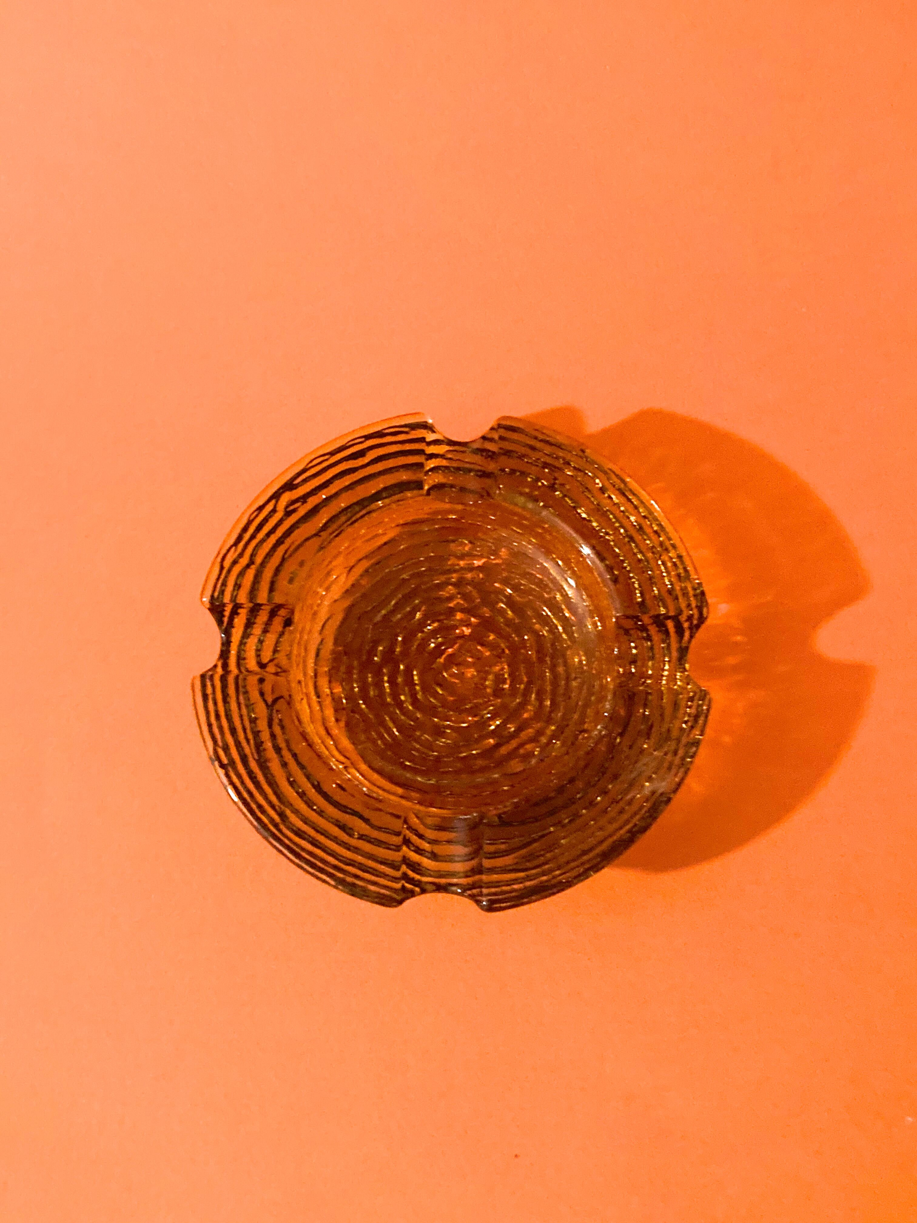 Empty chiseled pocket in amber glass