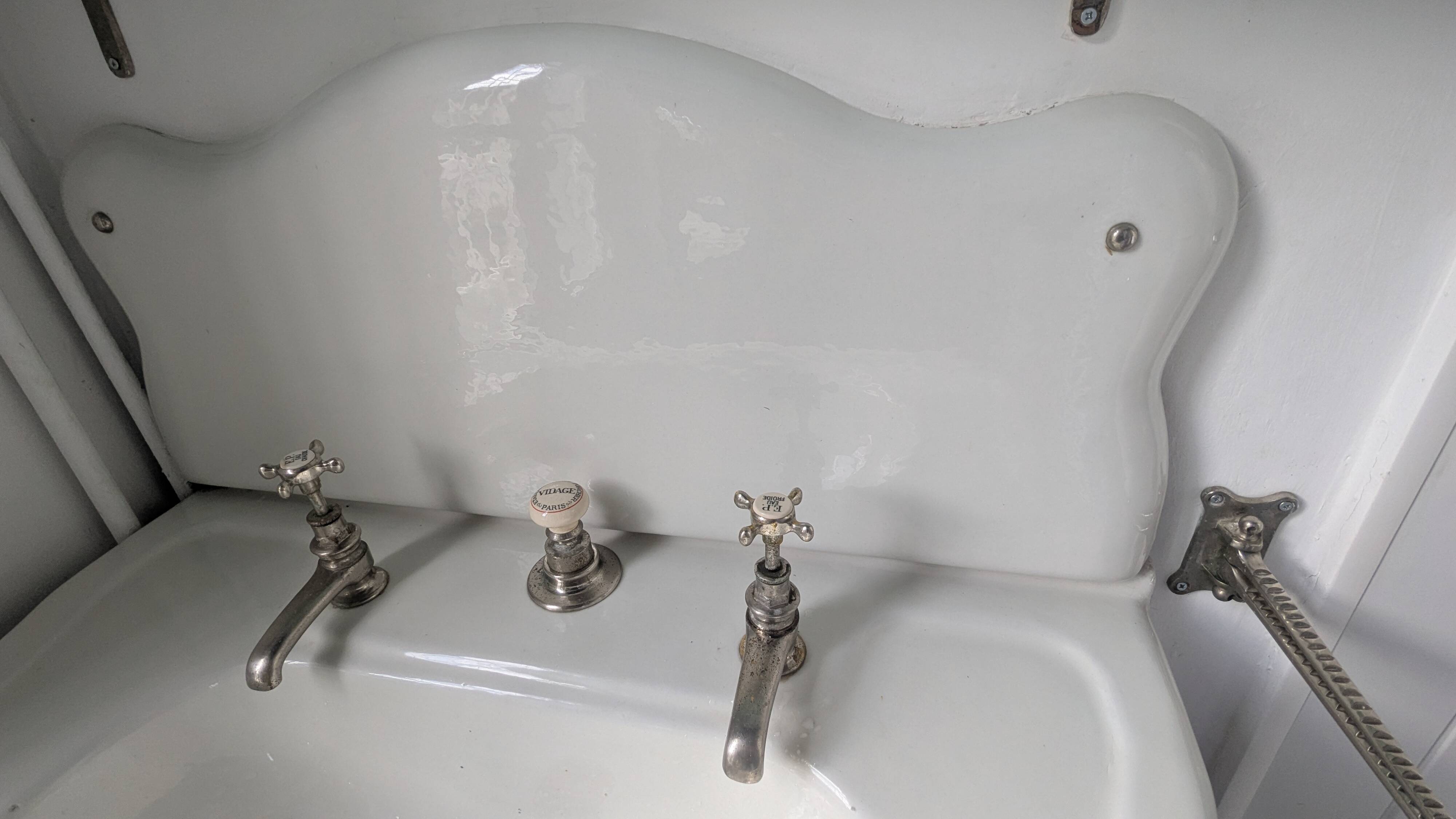 Set of a sink and its retro ceramic splashback.