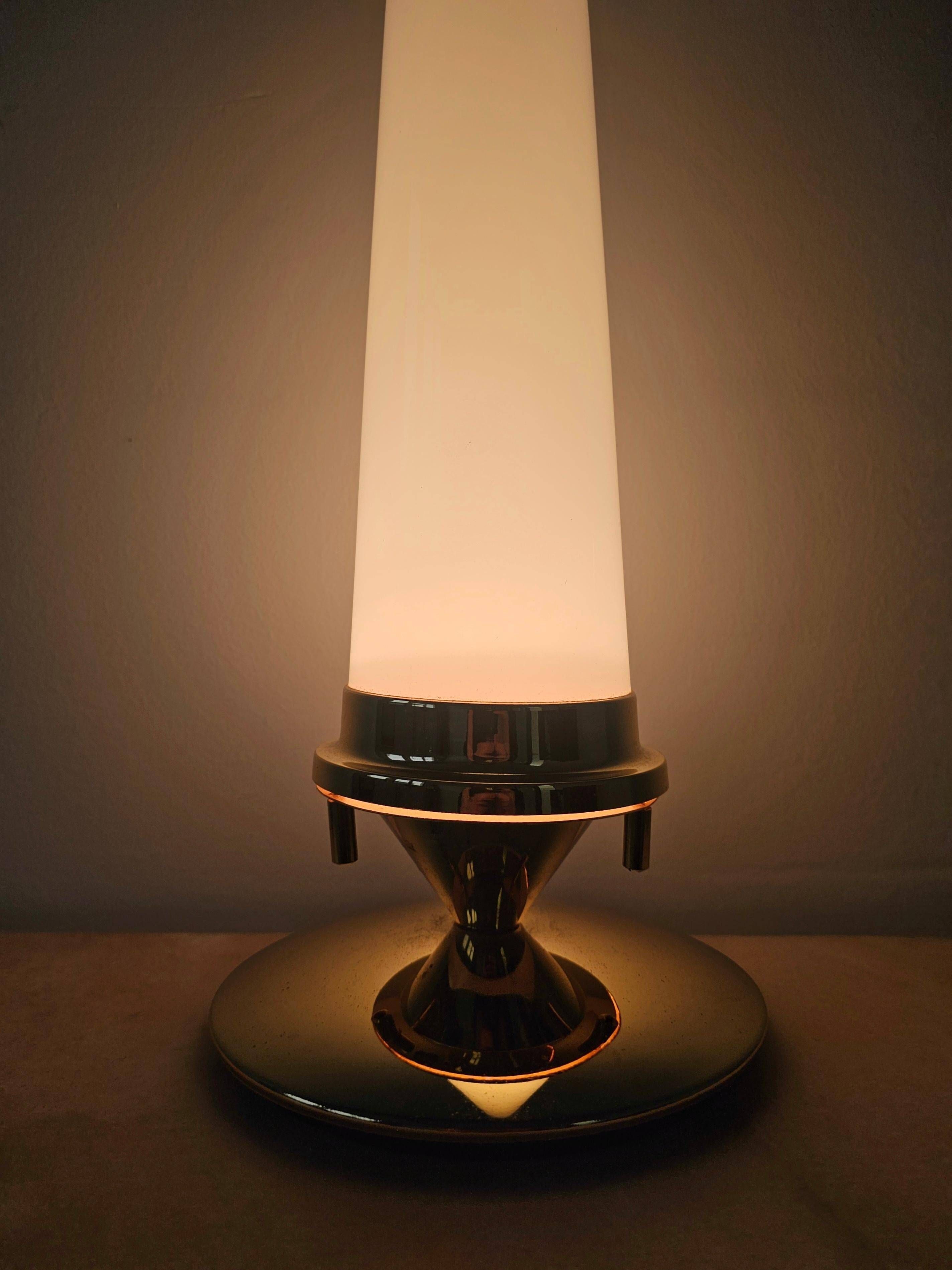 Pair of Hollywood Regency table lamps in brass with glass shades.