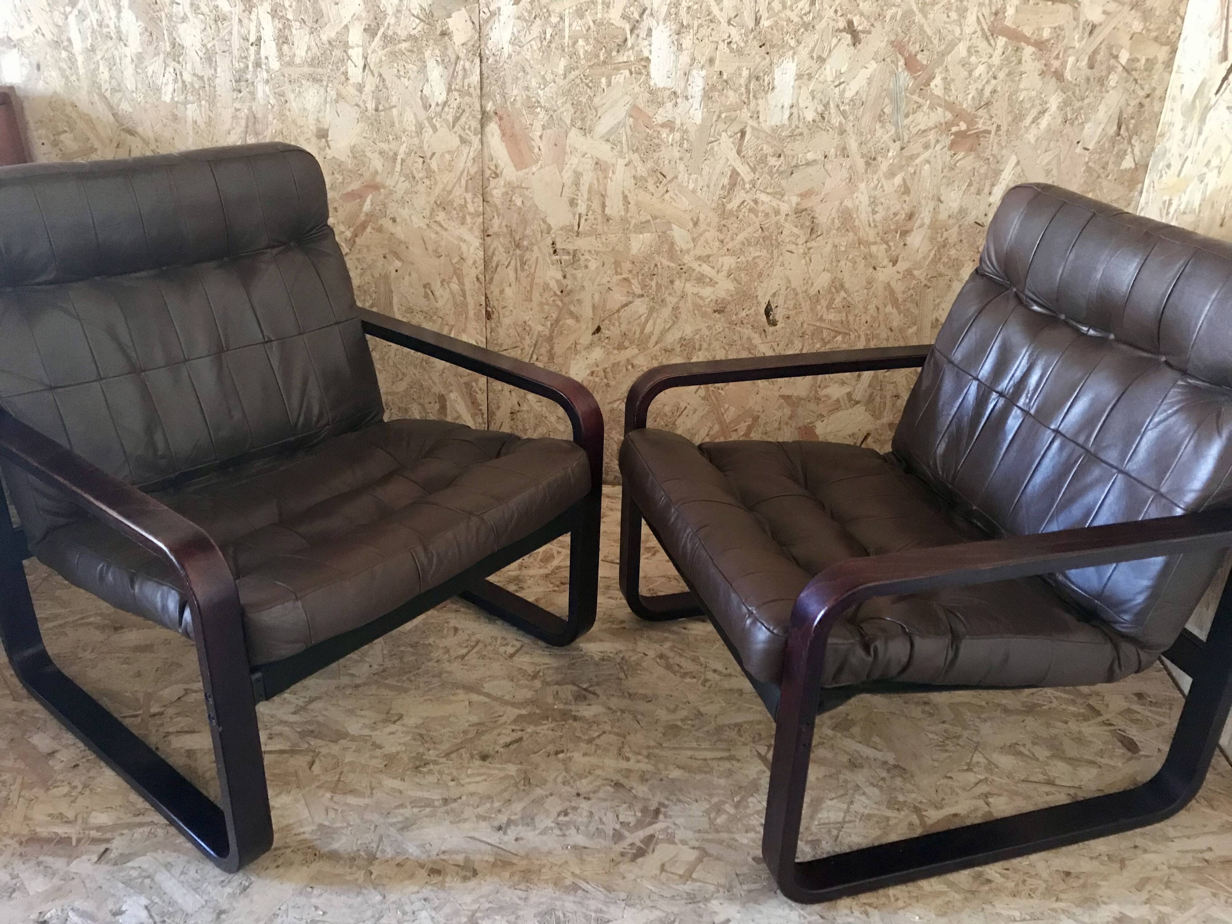 Pair of vintage armchairs in curved wood with suspended seat circa 1970-80.