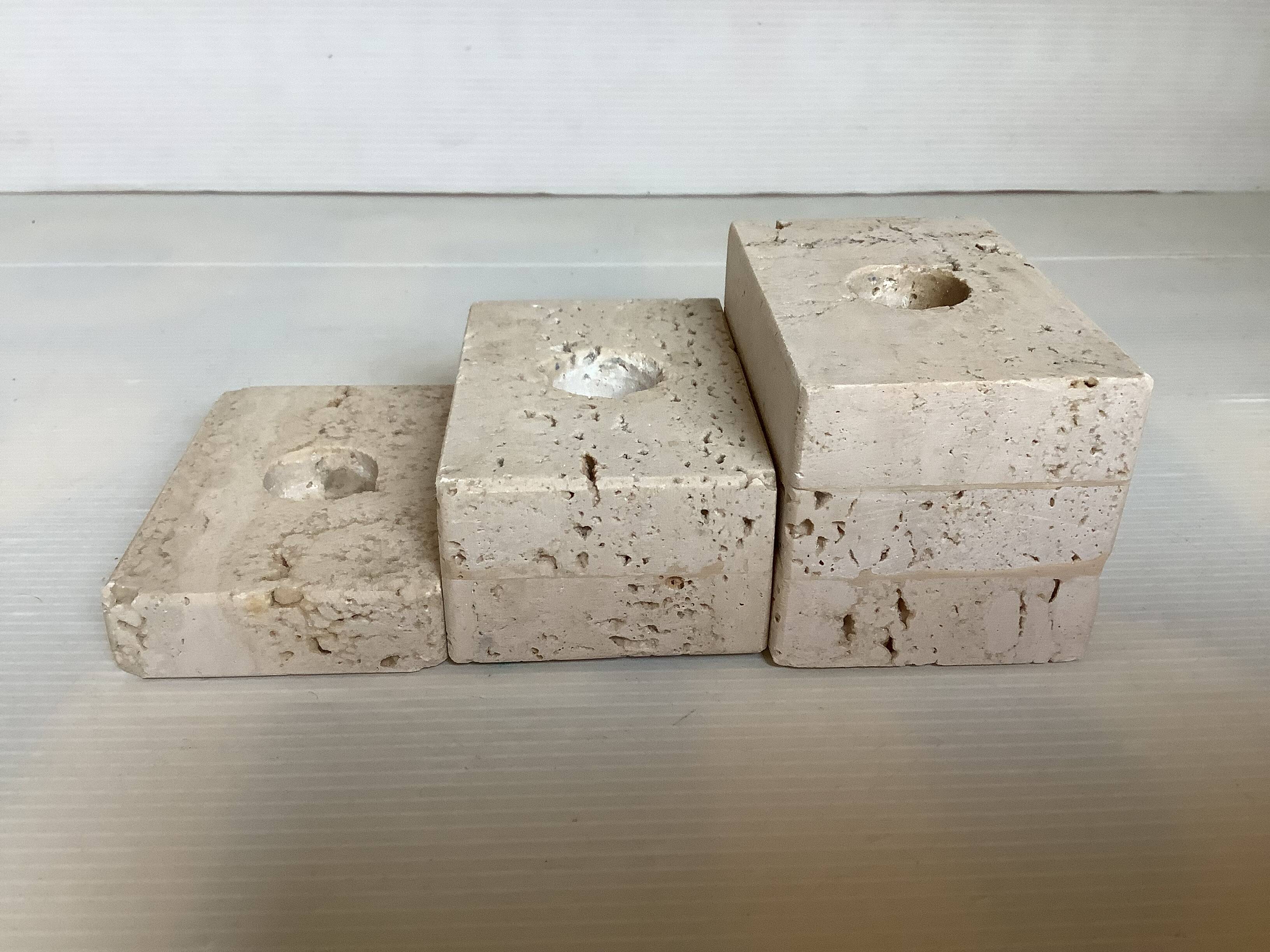 Trio of travertine candlesticks