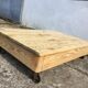 Old wooden school platform bass table on metal wheels