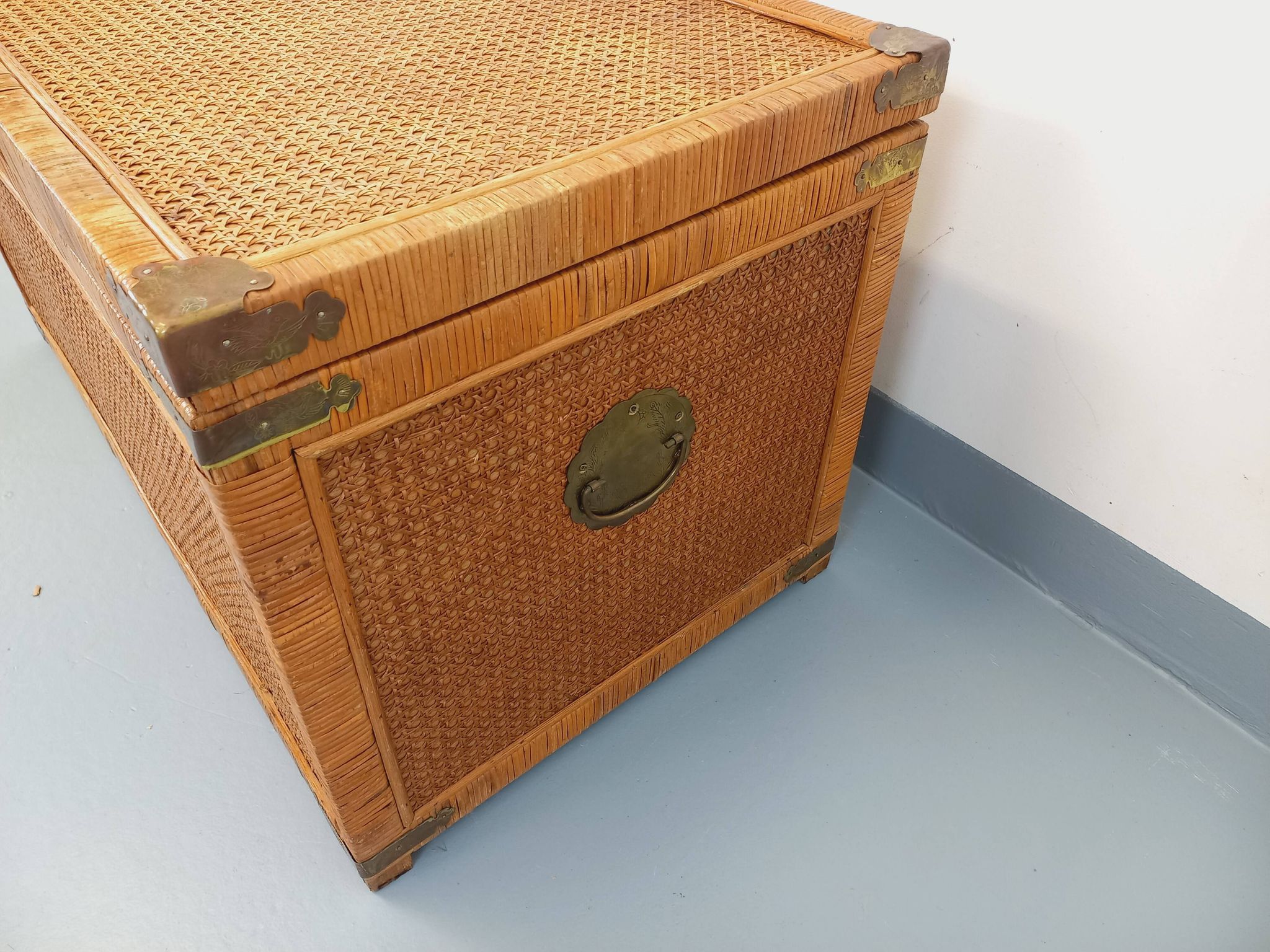 Vintage trunk in wood, rattan, caning, and brass.