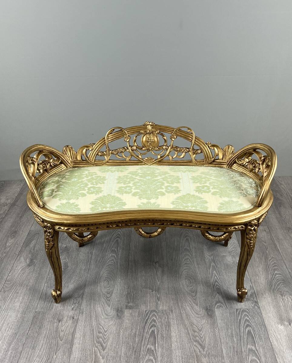 Louis XV style bench in carved and gilded wood, 20th century.