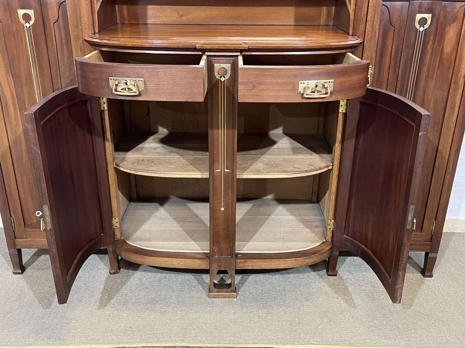 Art Nouveau mahogany buffet with clock in the style of G. Serrurier Bovy.