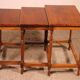 Nested tables in satin wood with brass inlays.