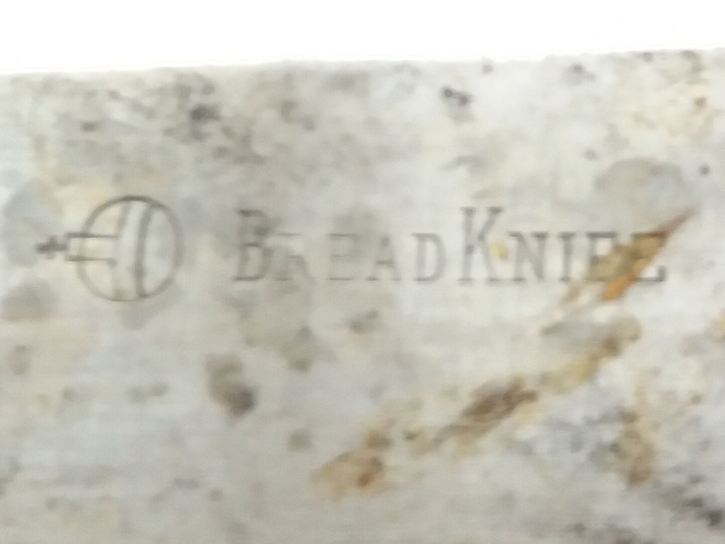 Old bread knife with a carved wooden handle