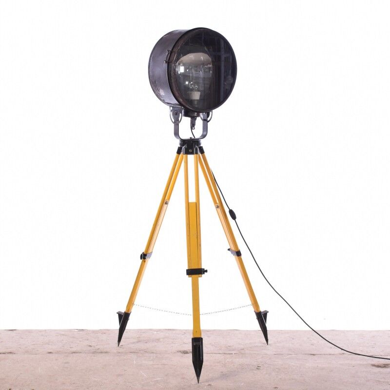 Old industrial spot on wooden tripod