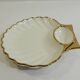 Shell-shaped porcelain pocket bowl from Queen’s Porcelain, with a gold rim.